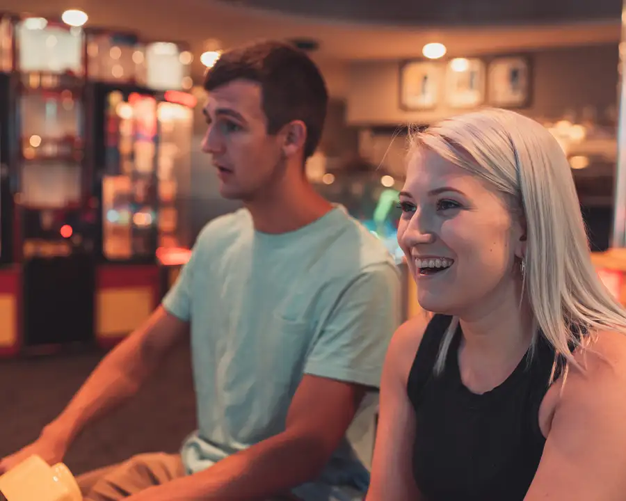 Man and woman smiling as they play arcade games at Bel-Air Bowl in Belleville, IL